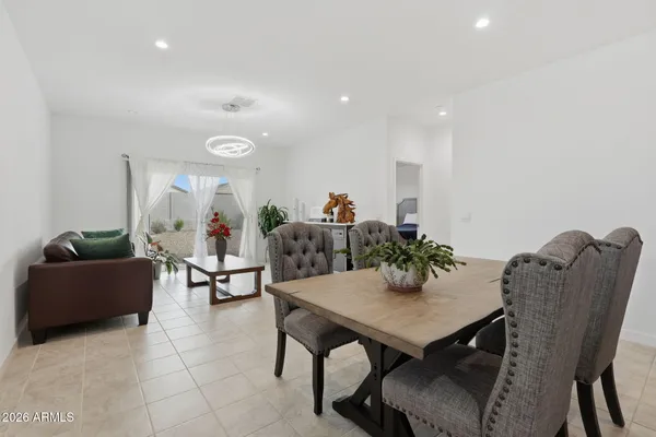 a spacious bedroom with a bed and a chandelier