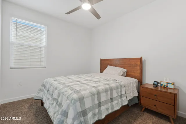a bedroom with a bed and cabinet