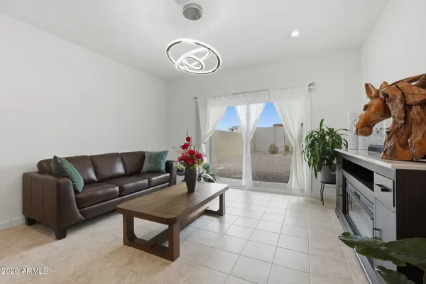 a living room with furniture and a chandelier