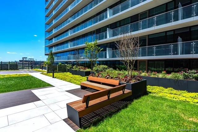 131-01 40 Road, Unit 19P Queens, NY 11354 - Photo 4 of 9 a wooden bench sitting in front of a building