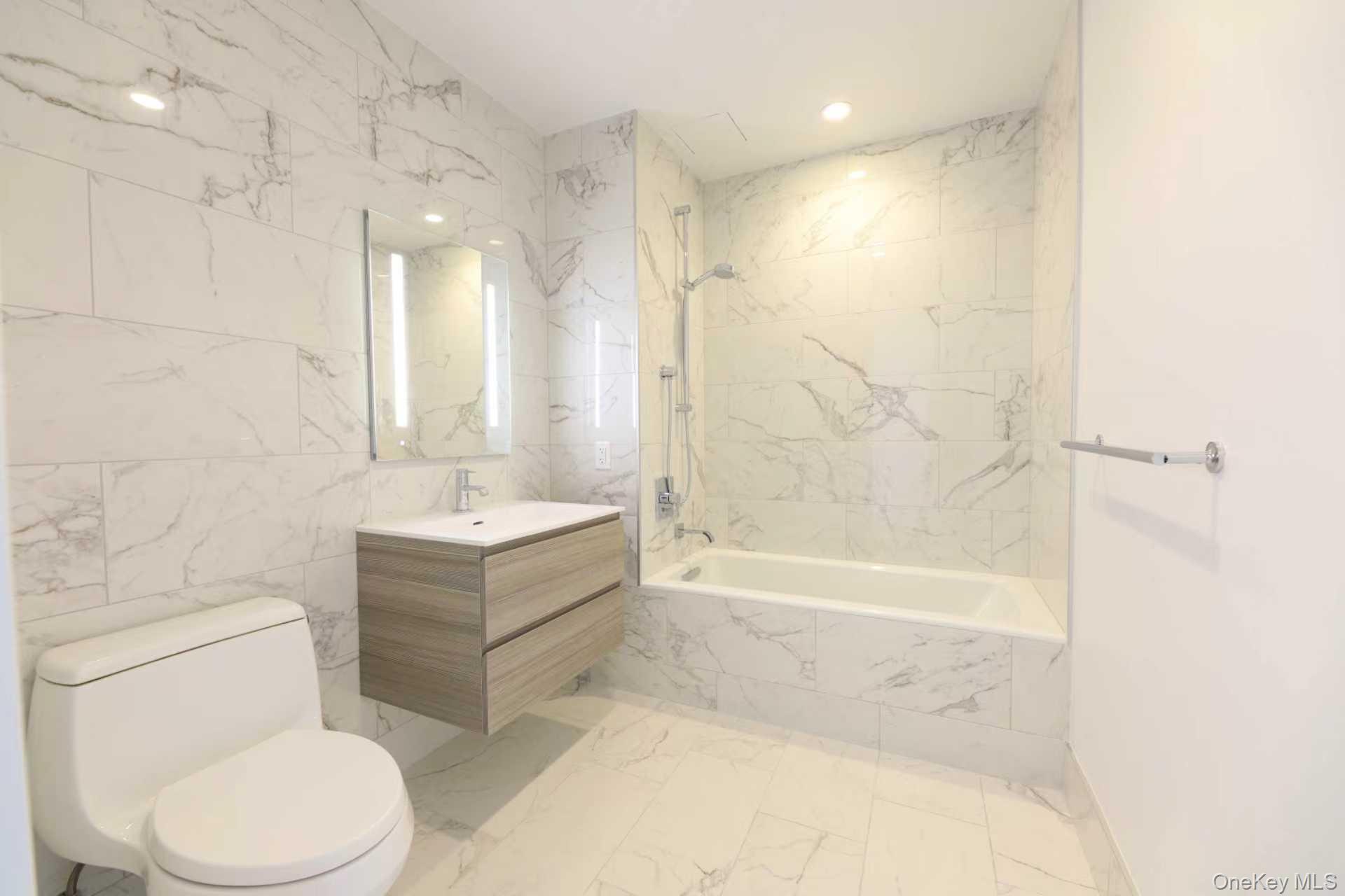 131-01 40 Road, Unit 19P Queens, NY 11354 - Photo 9 of 9 a bathroom with a sink a toilet and shower