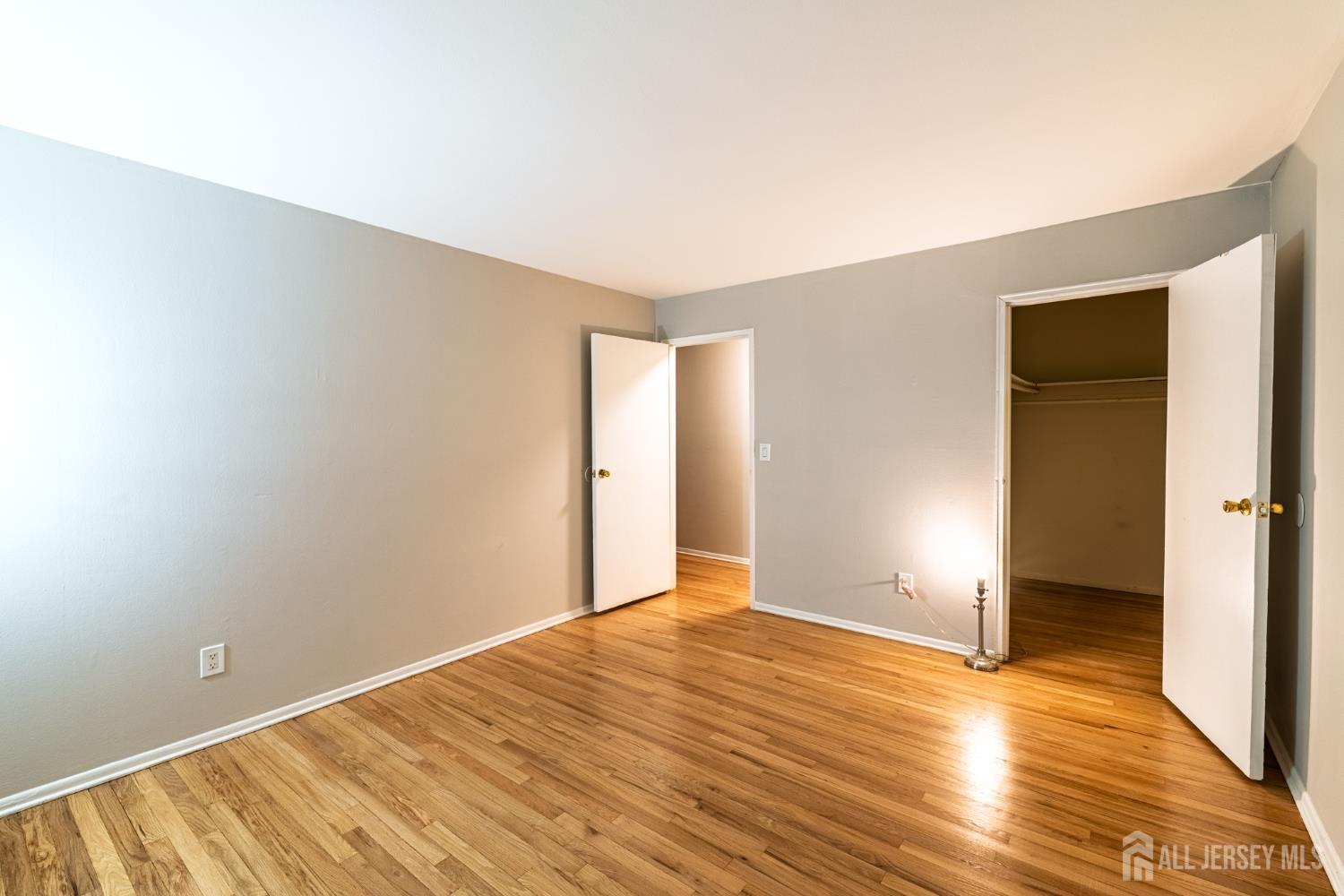93 Fox Road, Unit 6A Edison, NJ 08817 - Photo 15 of 24 a view of an empty room with wooden floor and closet