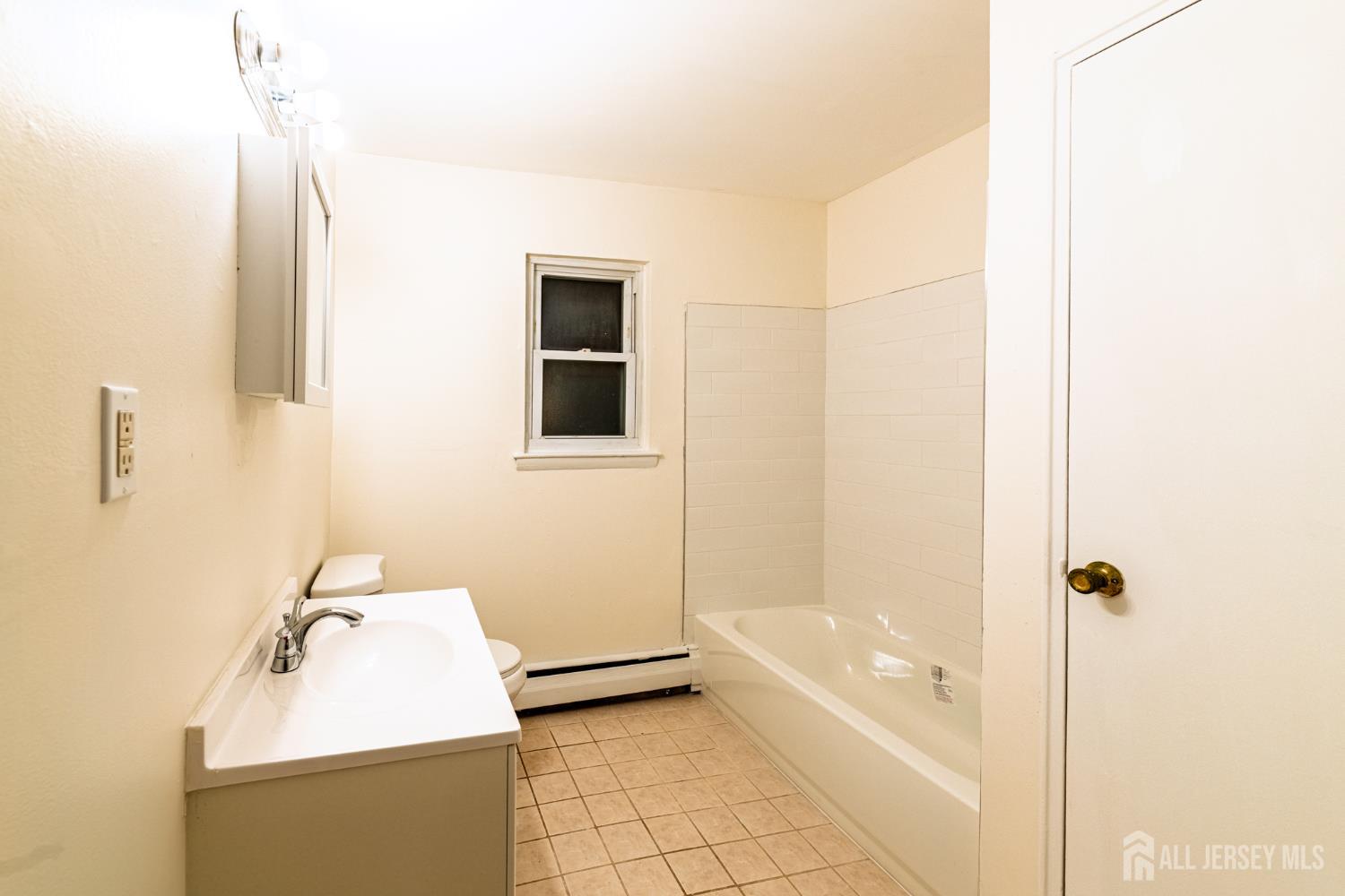 93 Fox Road, Unit 6A Edison, NJ 08817 - Photo 16 of 24 a bathroom with a tub sink and mirror