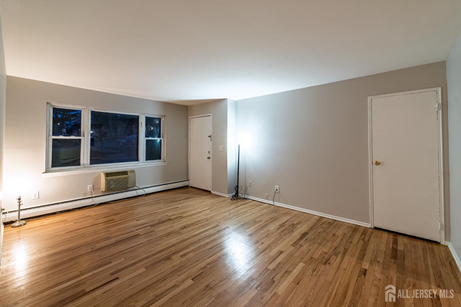 93 Fox Road, Unit 6A Edison, NJ 08817 - Photo 4 of 24 a view of an empty room with wooden floor and a window