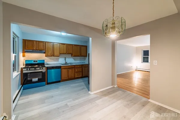 a kitchen with stainless steel appliances granite countertop a stove refrigerator and cabinets