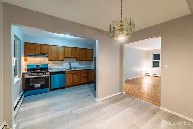 a kitchen with stainless steel appliances granite countertop a stove refrigerator and cabinets