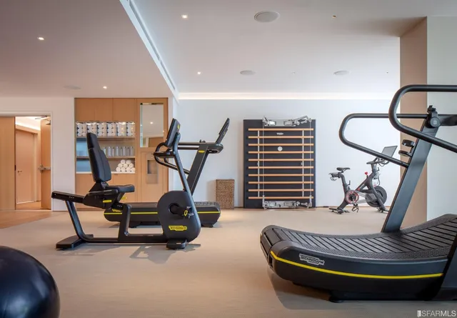 a room with gym equipment and a large window