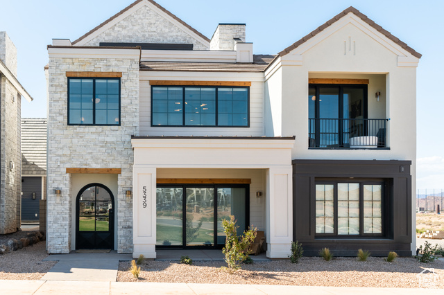 5339 Cyan Lane St. George, UT 84790 - Photo 2 of 44 View of front facade featuring stone siding, a balcony, stucco siding, and a chimney