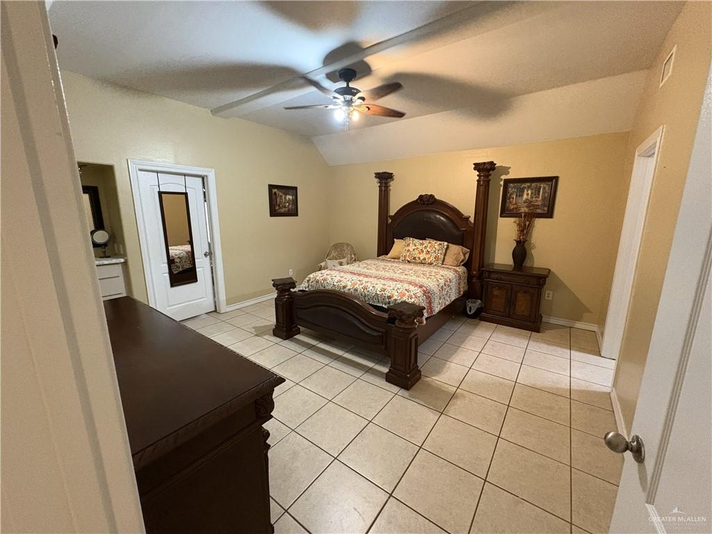 116 North Lupe Street Rio Grande City, TX 78582 - Photo 13 of 24 a bedroom with a bed and a walk in closet
