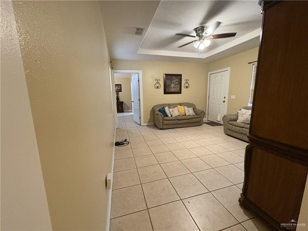 116 North Lupe Street Rio Grande City, TX 78582 - Photo 15 of 24 a bedroom with a bed and a chandelier