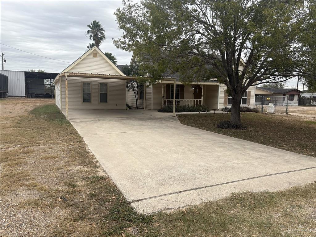 116 North Lupe Street Rio Grande City, TX 78582 - Photo 2 of 24 a front view of a house with a yard and garage