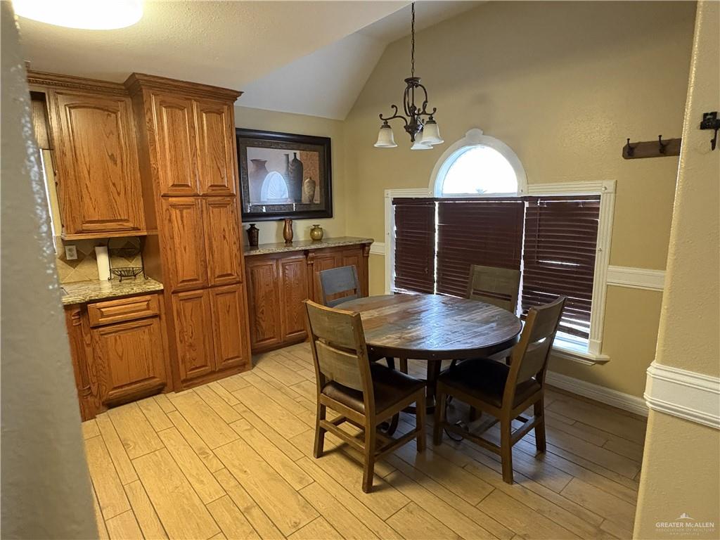 116 North Lupe Street Rio Grande City, TX 78582 - Photo 24 of 24 a kitchen with granite countertop stainless steel appliances a dining table chairs and granite counter tops