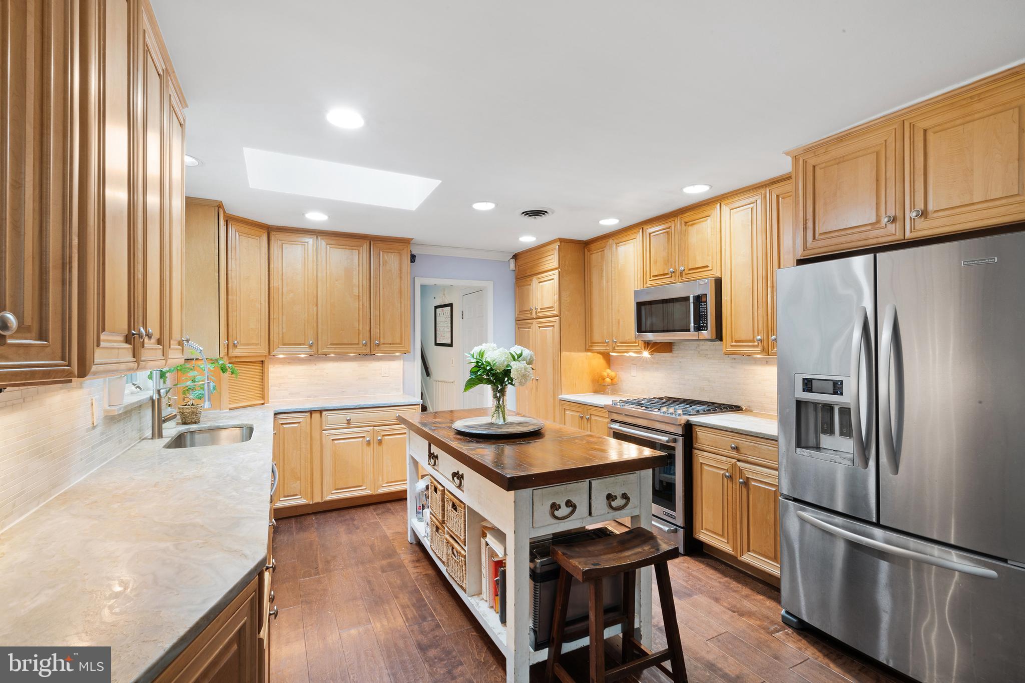209 Lake Road Basking Ridge, NJ 07920 - Photo 13 of 40 a kitchen with kitchen island granite countertop a stove refrigerator and microwave