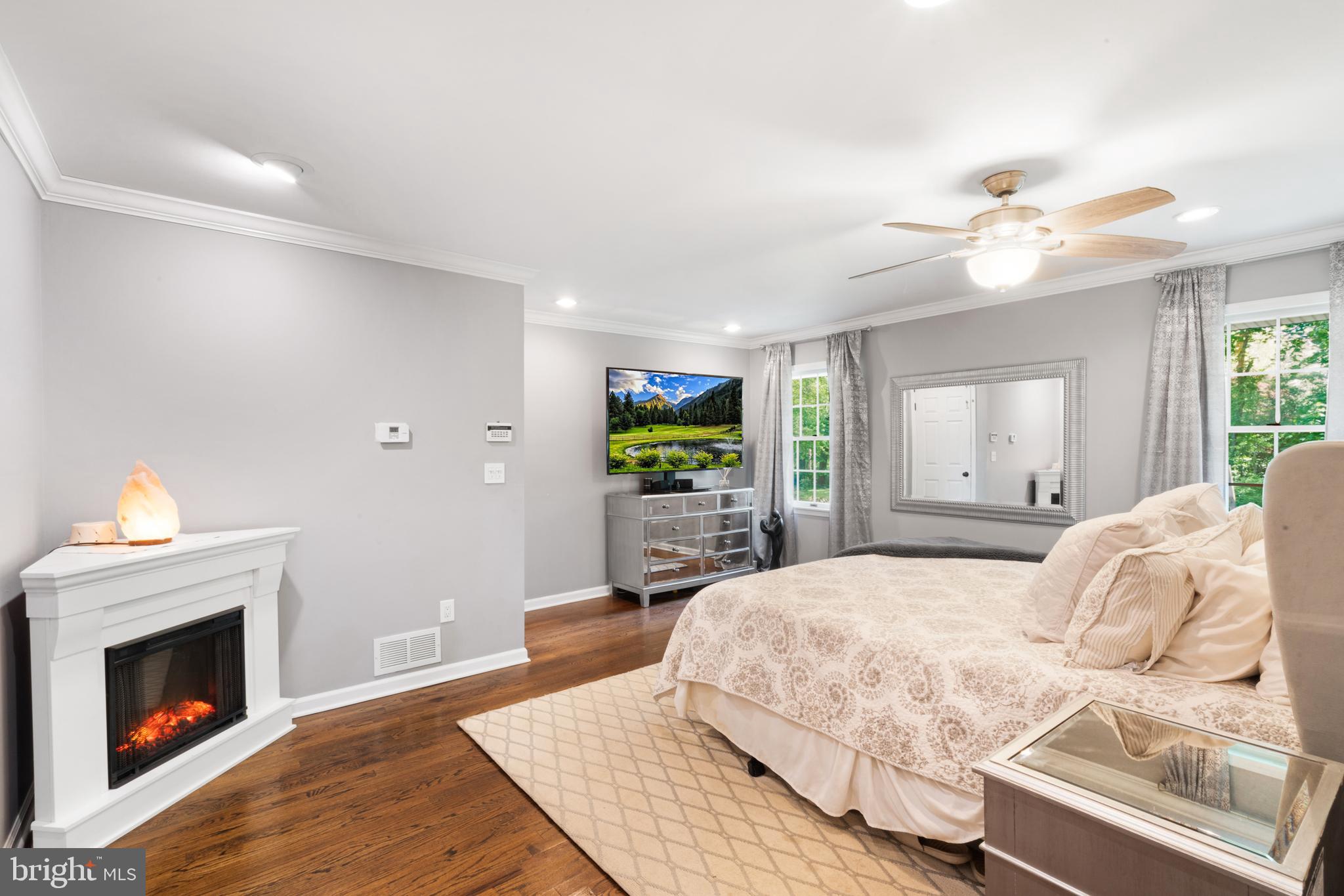 209 Lake Road Basking Ridge, NJ 07920 - Photo 17 of 40 a bedroom with a bed and a fireplace