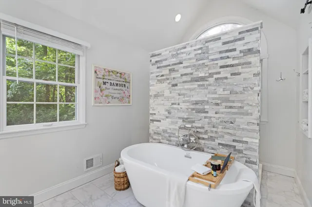 a bathroom with a bathtub and window