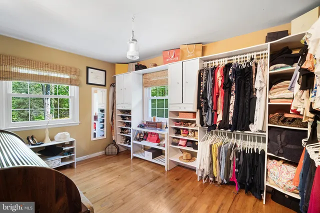 a bedroom with furniture and a large window