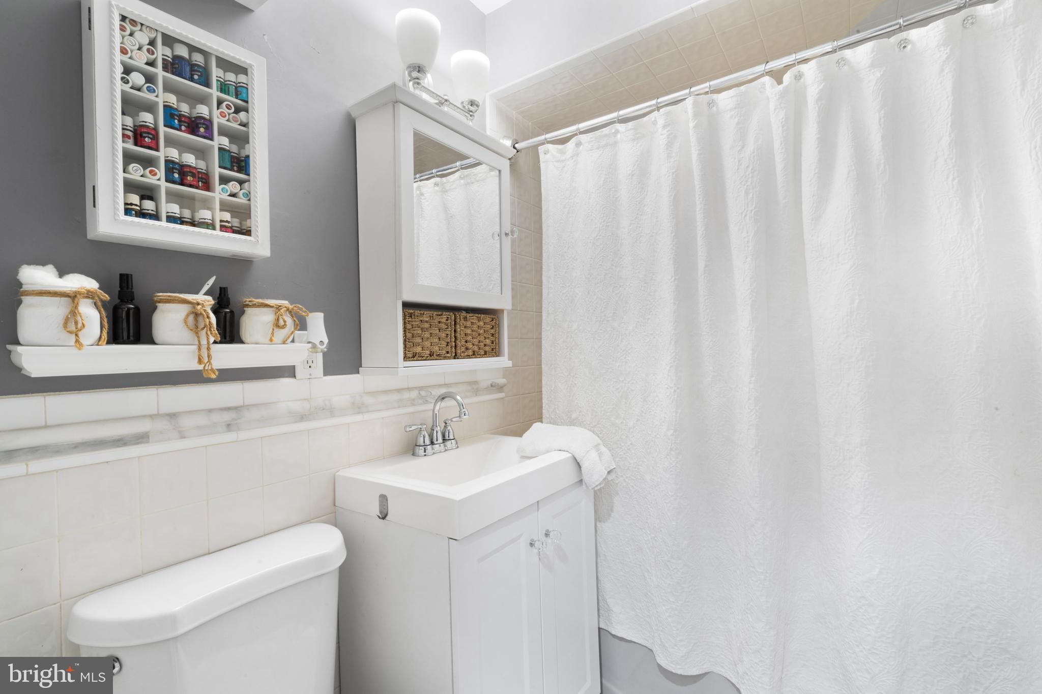 209 Lake Road Basking Ridge, NJ 07920 - Photo 30 of 40 a bathroom with a sink a toilet and a mirror