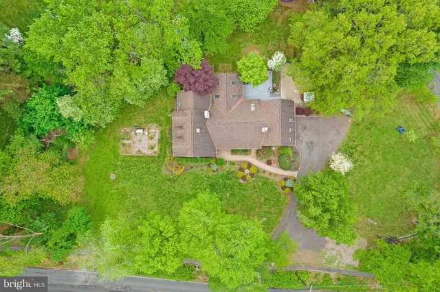 an aerial view of a house with a yard