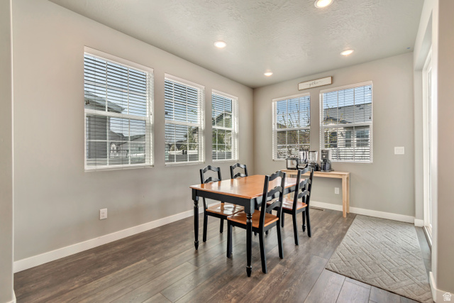 3232 West 1670th Street North Provo, UT 84601 - Photo 10 of 33 Dining area featuring hardwood / wood-style floors, plenty of natural light, recessed lighting, and a textured ceiling