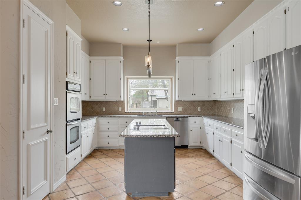 1201 Findlay Drive Arlington, TX 76012 - Photo 14 of 35 a kitchen with white cabinets and white appliances