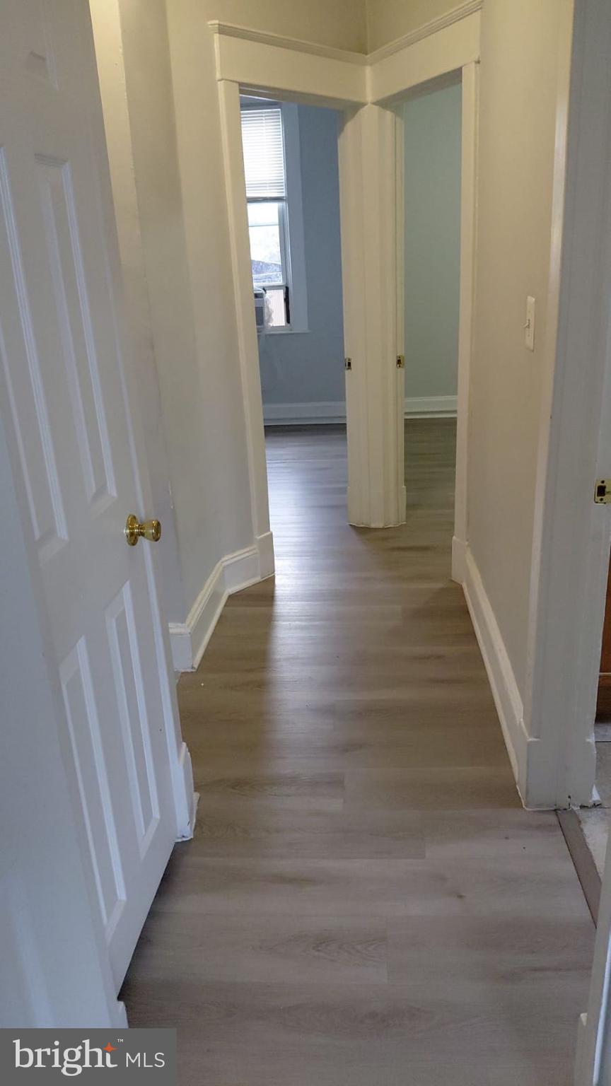 2518 Barclay Street Baltimore, MD 21218 - Photo 11 of 16 a view of a hallway view with wooden floor and staircase