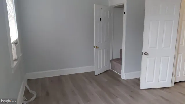 a view of room with window and wooden floor