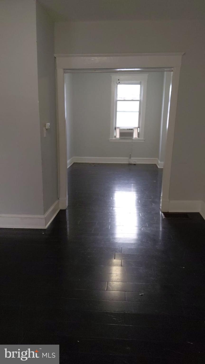 2518 Barclay Street Baltimore, MD 21218 - Photo 13 of 16 a view of room with window and wooden floor