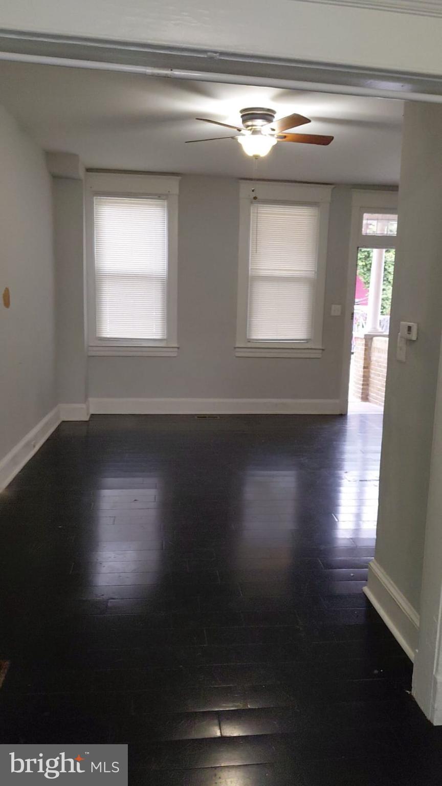 2518 Barclay Street Baltimore, MD 21218 - Photo 14 of 16 a view of an empty room with wooden floor and a window