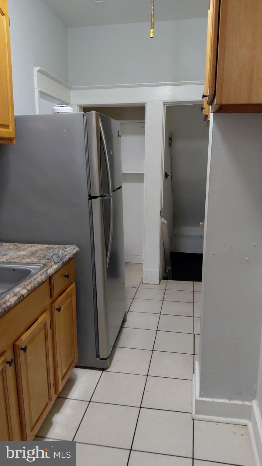 2518 Barclay Street Baltimore, MD 21218 - Photo 7 of 16 a kitchen with stainless steel appliances granite countertop a refrigerator and a stove