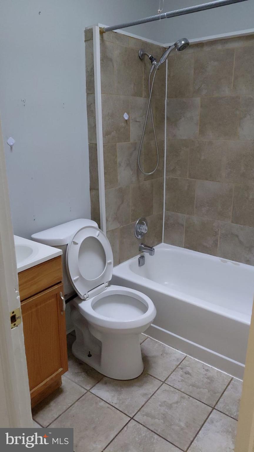 2518 Barclay Street Baltimore, MD 21218 - Photo 10 of 16 a bathroom with a granite countertop sink toilet and shower
