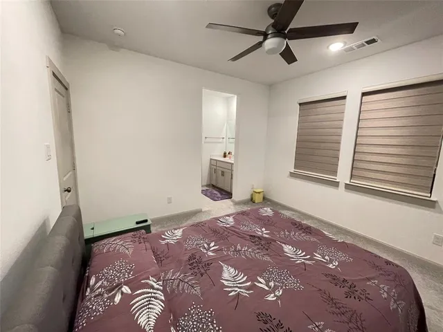 a bedroom with a large bed and a window