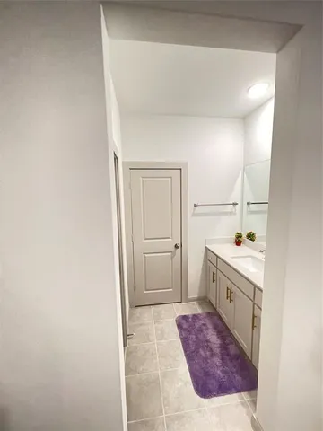 a bathroom with a bathtub sink and mirror