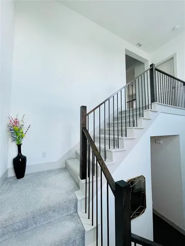 a view of staircase with wooden floor and a potted plant