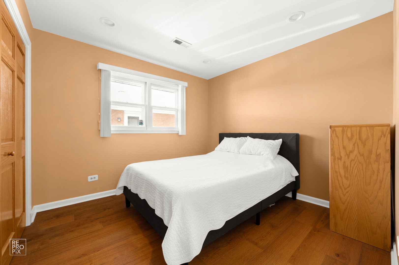 4433 Madison Avenue Brookfield, IL 60513 - Photo 14 of 16 a large bed sitting in a bedroom next to a window