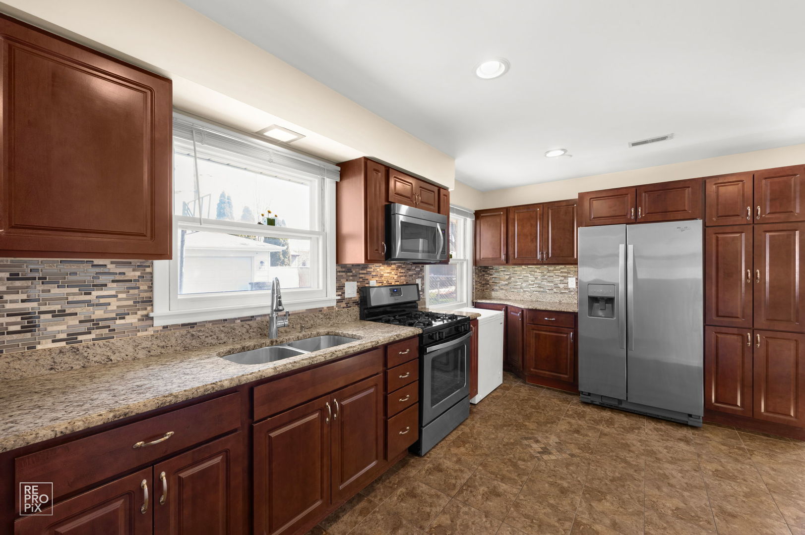 4433 Madison Avenue Brookfield, IL 60513 - Photo 7 of 16 a kitchen with granite countertop stainless steel appliances a refrigerator stove top oven and sink