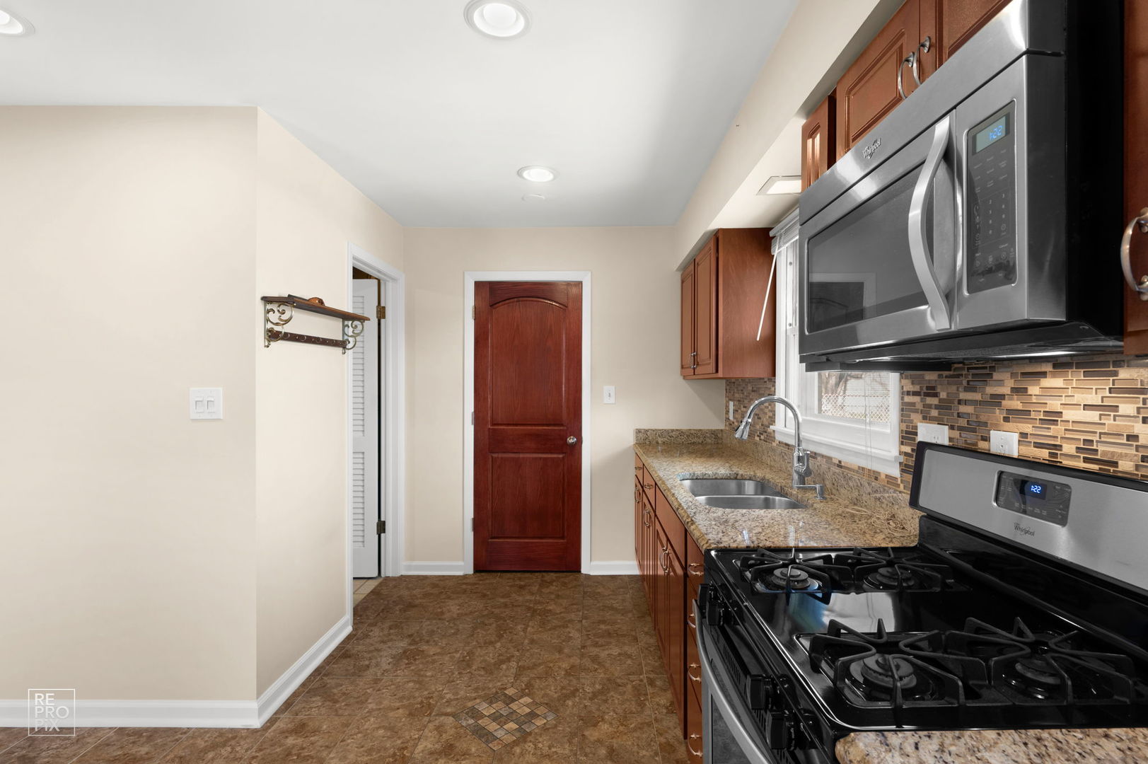 4433 Madison Avenue Brookfield, IL 60513 - Photo 8 of 16 a kitchen with stainless steel appliances granite countertop a stove and a refrigerator