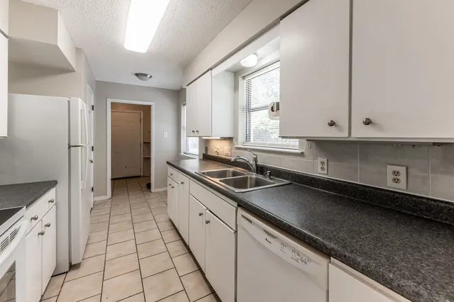 a kitchen with a sink and cabinets