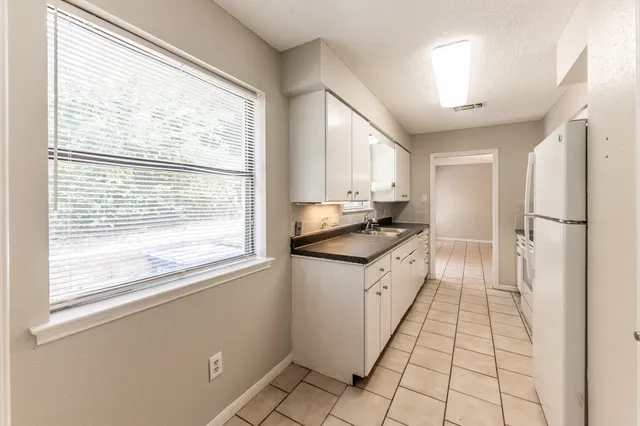 a kitchen with a sink a counter top space and stainless steel appliances