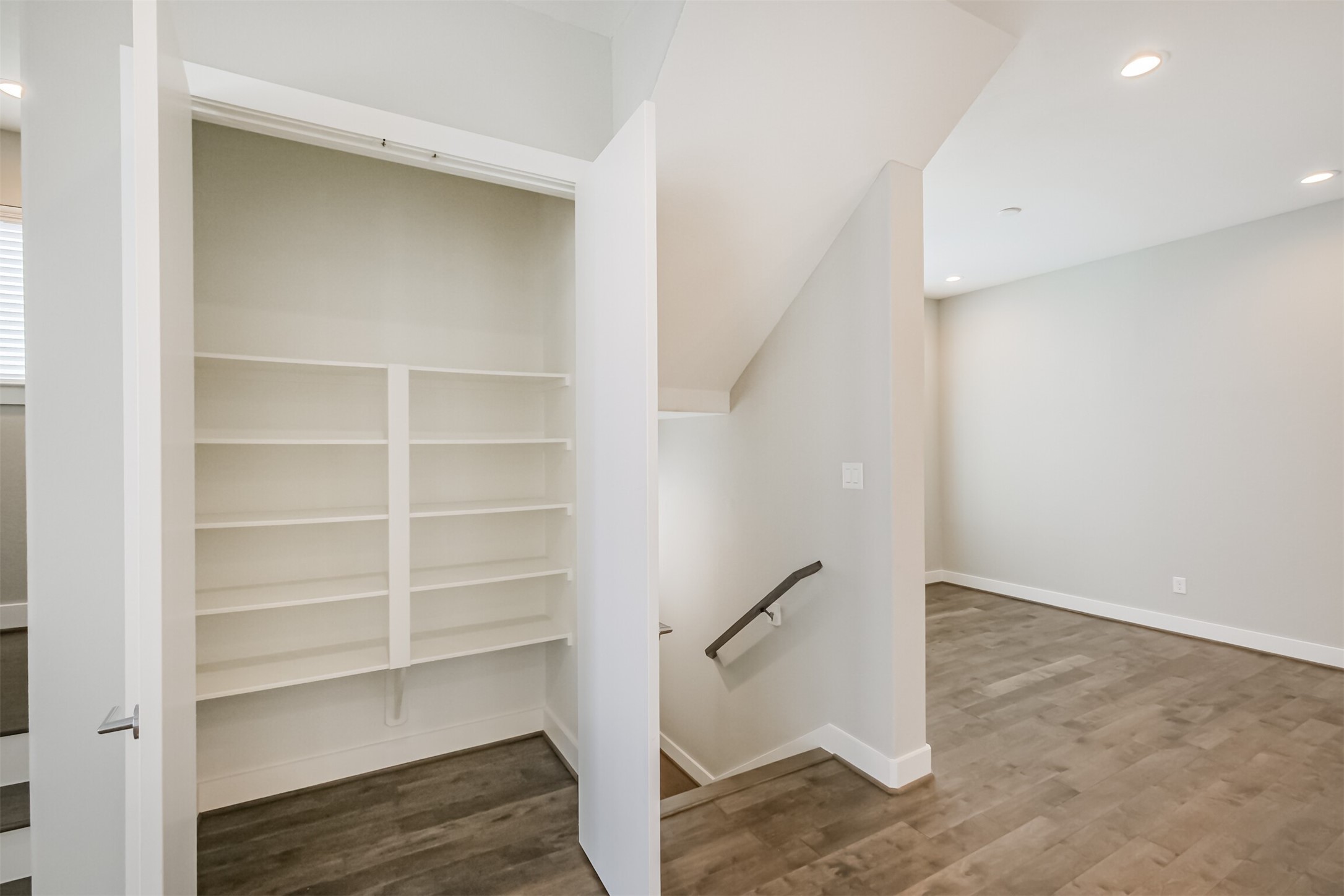 1305 Mayfair Clarkson Lane Houston, TX 77055 - Photo 21 of 34 Atop the staircase sits an additional storage closet with built-in shelving.