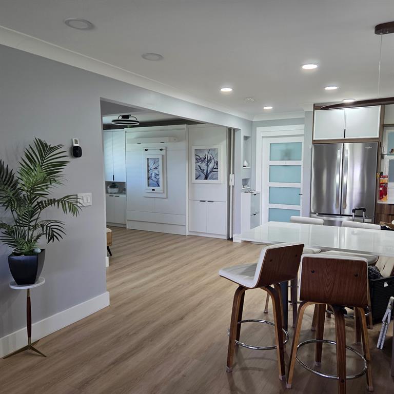 300 Southwest Golfview Terrace, Unit 135 Boynton Beach, FL 33426 - Photo 13 of 25 a view of a dining room with furniture and wooden floor