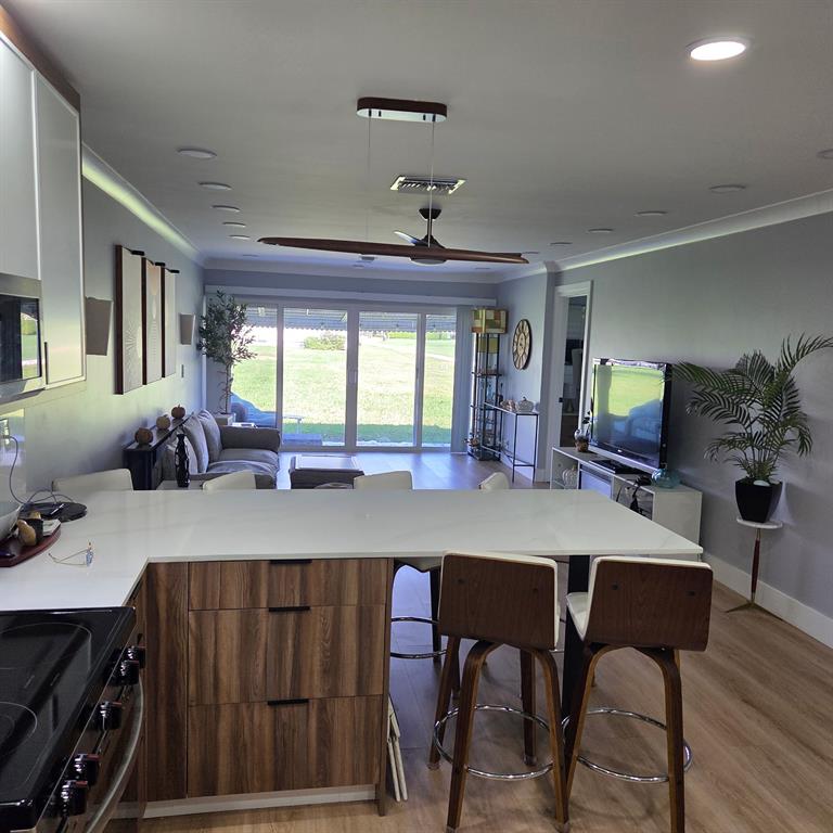 300 Southwest Golfview Terrace, Unit 135 Boynton Beach, FL 33426 - Photo 18 of 25 a view of a dining room with furniture and window