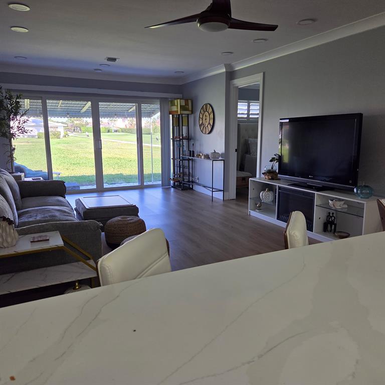 300 Southwest Golfview Terrace, Unit 135 Boynton Beach, FL 33426 - Photo 21 of 25 a living room with furniture and a flat screen tv