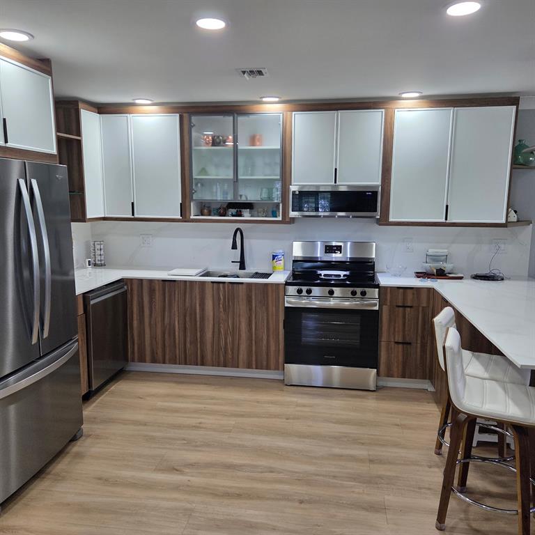 300 Southwest Golfview Terrace, Unit 135 Boynton Beach, FL 33426 - Photo 6 of 25 a kitchen with stainless steel appliances granite countertop a refrigerator sink and cabinets