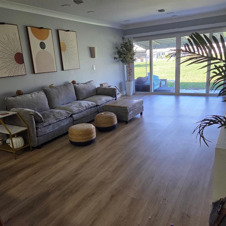 300 Southwest Golfview Terrace, Unit 135 Boynton Beach, FL 33426 - Photo 9 of 25 a living room with furniture and a large window
