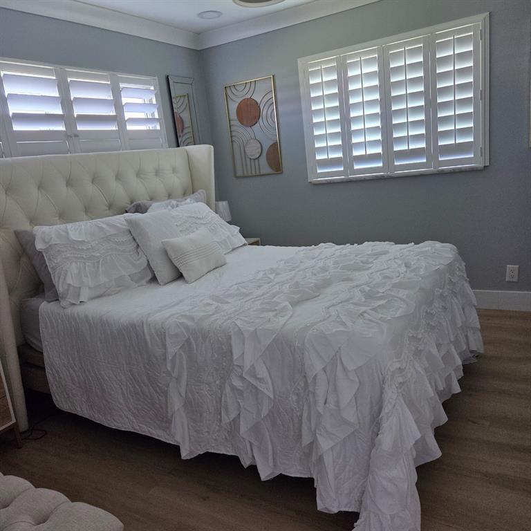 300 Southwest Golfview Terrace, Unit 135 Boynton Beach, FL 33426 - Photo 10 of 25 a bed sitting in a bedroom next to a window