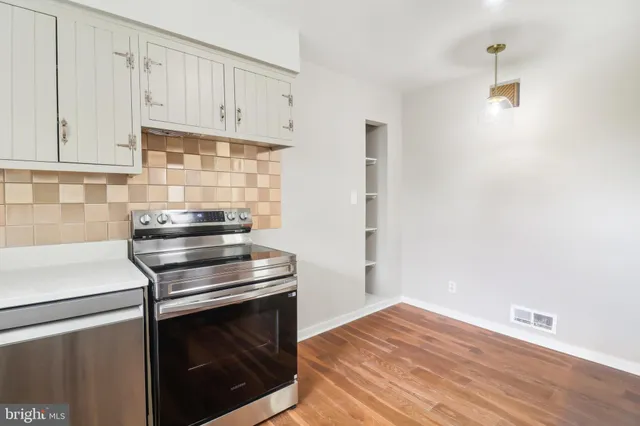 a kitchen with cabinets and stainless steel appliances