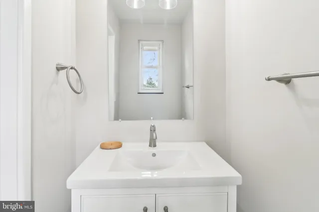 a bathroom with a sink a vanity and a mirror