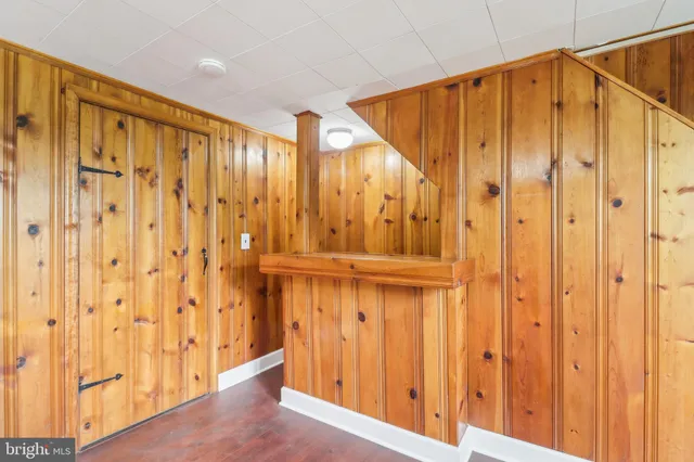 a view of a room with a door and a ceiling fan