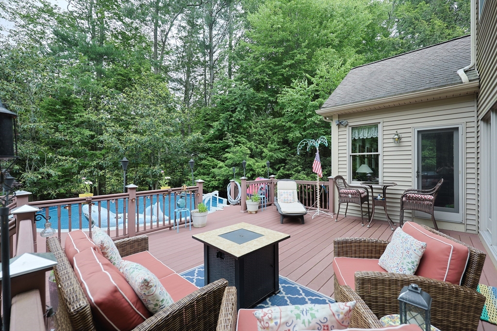70 Azalea Way Hanson, MA 02341 - Photo 5 of 42 a view of a patio with couches table and chairs and potted plants