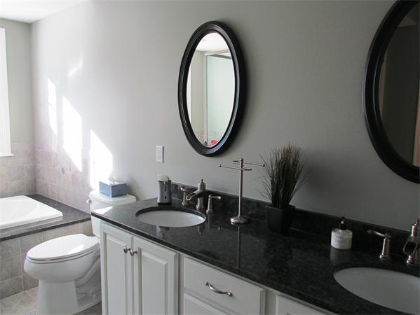313 South Main Street Andover, MA 01810 - Photo 15 of 26 a bathroom with a granite countertop sink and a mirror